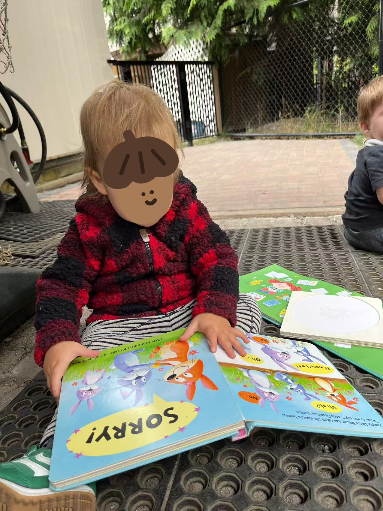 Children enjoying story time outdoors at Forest Cubs Childcare